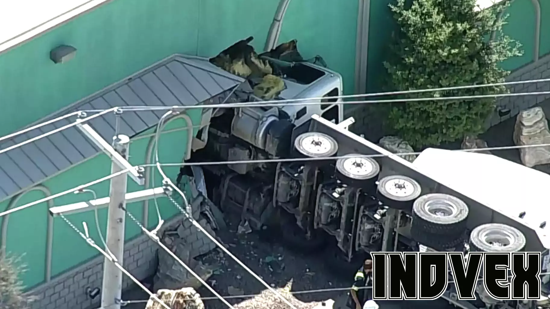 Concrete truck overturns, crashes into Dallas business, authorities say